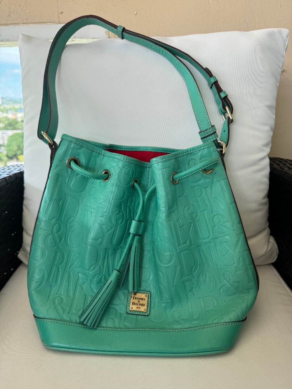 Dooney & Bourke Turquoise Embossed Logo Leather Drawstring Bucket Shoulder Bag
